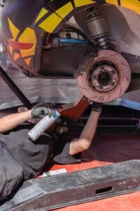 Mechanic Under Car Repairing Brake